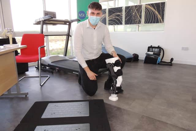 Sports scientist Damian Bochniak with his range of technology for helping patients reduce pain and recover from treatment. EMN-220124-124806001
