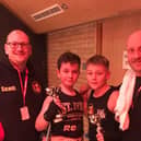 The young fighters with Boston coaches Scott Harmon and Matt Mooney.