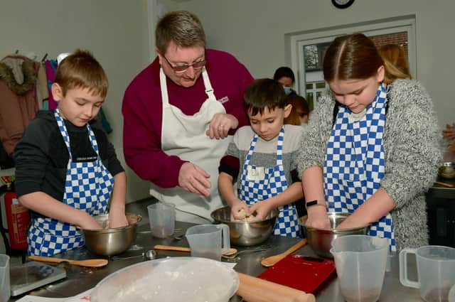 Education work lead Paul Reid, helping Mason Atkins, 10, Caleb Smith, nine, and Taylor-Jade Smith, 11.