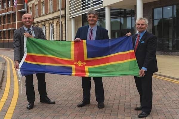 From left, Coun Rob Waltham, leader of North Lincolnshire Council; Coun Phillip Jackson, leader of North East Lincolnshire Council; and Coun Martin Hill, leader of Lincolnshire County Council, pictured with the Lincolnshire flag. EMN-220202-135544001