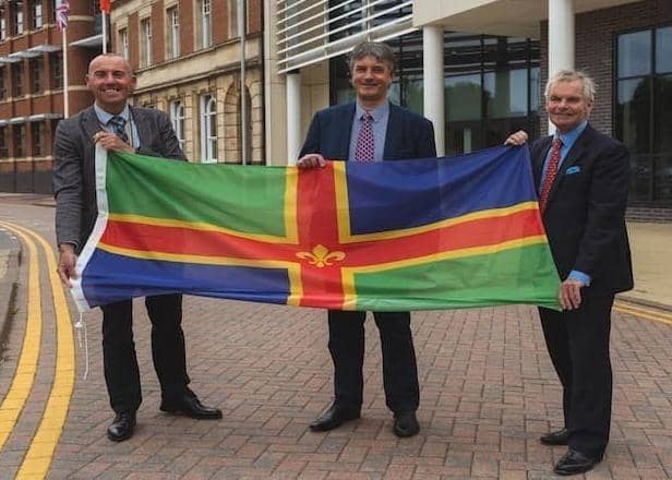 From left, Coun Rob Waltham, leader of North Lincolnshire Council; Coun Phillip Jackson, leader of North East Lincolnshire Council; and Coun Martin Hill, leader of Lincolnshire County Council, pictured with the Lincolnshire flag. EMN-220202-135544001
