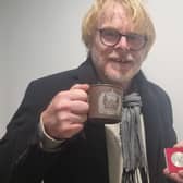 Skegness Community Champion John Byford with the coin and mug he received when he was at school and the nation was celebrating the Queen's Silver Jubilee. Now he is looking forward to celebrating the Queen's Platinum Jubilee with his grandchildren.