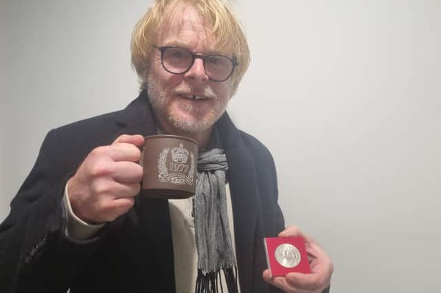 Skegness Community Champion John Byford with the coin and mug he received when he was at school and the nation was celebrating the Queen's Silver Jubilee. Now he is looking forward to celebrating the Queen's Platinum Jubilee with his grandchildren.