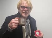 Skegness Community Champion John Byford with the coin and mug he received when he was at school and the nation was celebrating the Queen's Silver Jubilee. Now he is looking forward to celebrating the Queen's Platinum Jubilee with his grandchildren.