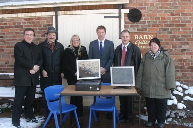 Skegness Academy presenting a donation of computers and more to the Church Farm Village.