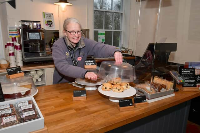 The cafe was doing a good trade in hot drinks. Serving cake is Helen Baker, a member of staff who is food and beverage team leader.