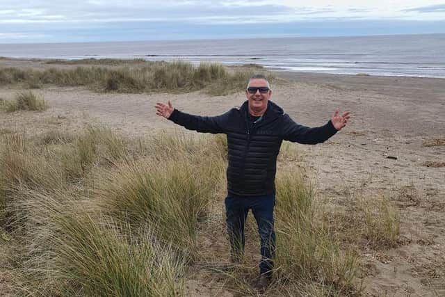Simon Adderley on the beach in Ingoldmells which he is selling.