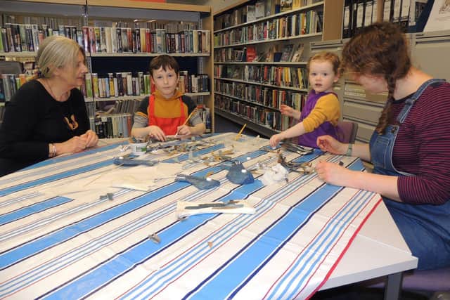 Making their fishy sculptures in Sleaford library for its RiverLight Festival window display. from left - Chrissy Venus, Monty Cope, eight, Esther Cope, two, and Sophie Cope from Sleaford. EMN-220215-171625001