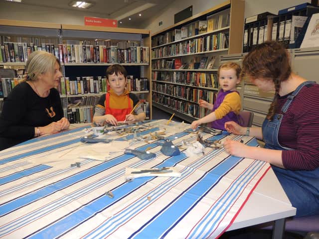 Making their fishy sculptures in Sleaford library for its RiverLight Festival window display. from left - Chrissy Venus, Monty Cope, eight, Esther Cope, two, and Sophie Cope from Sleaford. EMN-220215-171625001