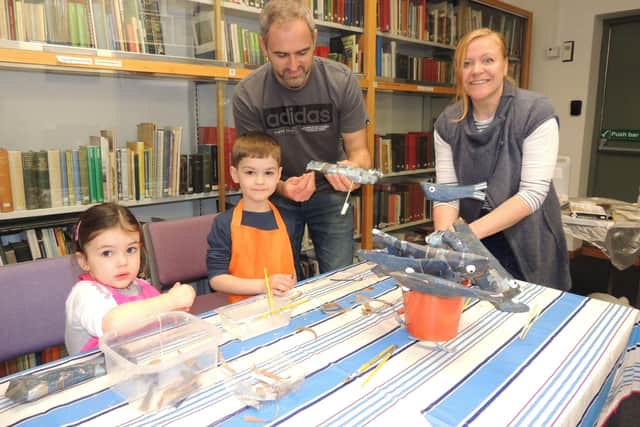 Fish making workshop leader and artist Ruth Pigott guides Will Titchband and his children Darcie, three, and Oscar, five, of Sleaford. EMN-220215-171614001