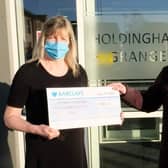 Holdingham Grange manager Hazel Whittaker presents the donation to Rotary president Cath Hamblin.