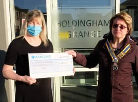 Holdingham Grange manager Hazel Whittaker presents the donation to Rotary president Cath Hamblin.
