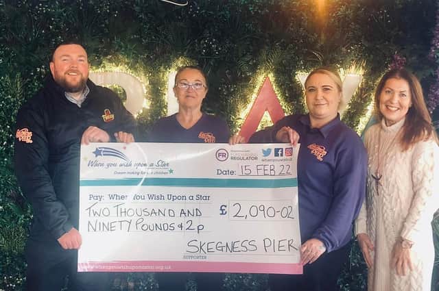 Staff of Skegness Pier with a cheque for £2,090.02 presented to the When You Wish Upon A Star charity.