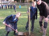 Lydia Littlejohn, 12, and Cameron Hughes, 11, both poetry competition winners, plant one of the last two lime trees for the Avenue of Remembrance at St George's Academy. EMN-220226-115826001