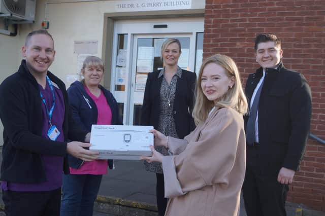 Healthcare assistant Leigh Proctor receives the equipment from Shannon Friend, watched by Sally Green, Tracy Dewhurst and Matthew Foster EMN-220217-074757001