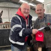 Steve Warmsley with Kye the donkey and John Nuttall at the cheque presentation.