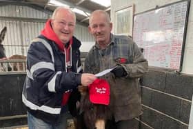 Steve Warmsley with Kye the donkey and John Nuttall at the cheque presentation.