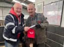 Steve Warmsley with Kye the donkey and John Nuttall at the cheque presentation.