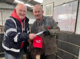 Steve Warmsley with Kye the donkey and John Nuttall at the cheque presentation.