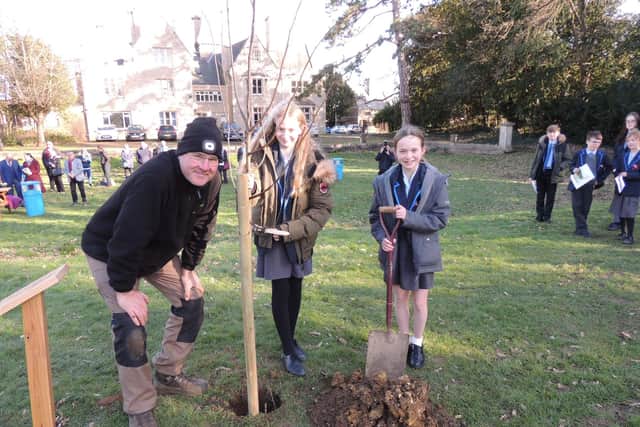 Poets Emily Gaskin and Alice James, both 12, plant one of the last two lime trees in the Avenue of Remembrance at St George's Academy, Sleaford. EMN-220226-115837001