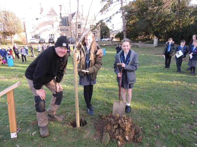 Poets Emily Gaskin and Alice James, both 12, plant one of the last two lime trees in the Avenue of Remembrance at St George's Academy, Sleaford. EMN-220226-115837001