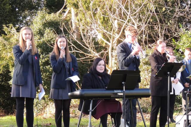 Singers and musicians of St George's Academy lead the hymn I Voiw To Thee My Country. EMN-220226-115847001