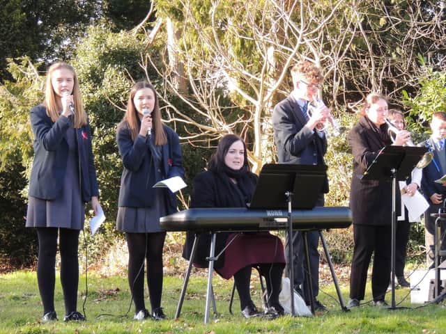 Singers and musicians of St George's Academy lead the hymn I Voiw To Thee My Country. EMN-220226-115847001