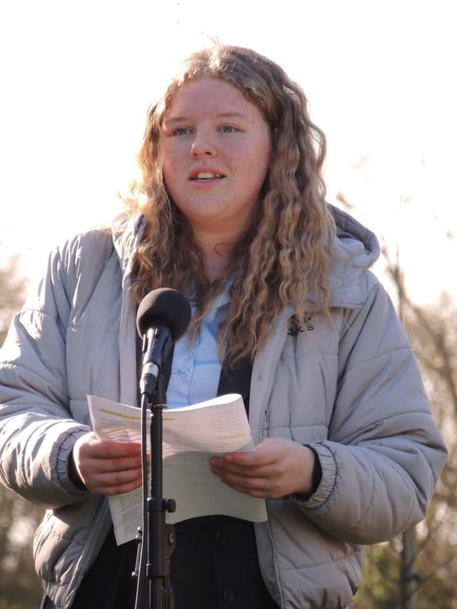 One of the poetry competition winners reads her words at the ceremony. EMN-220226-115816001