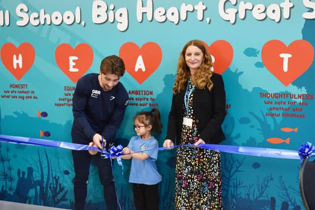 The ribbon is cut on the new hall! Sam Oldham (left) is pictured with the Fishtoft Academy pupil who originally put the first spade in the ground and Emma Hadley (right).