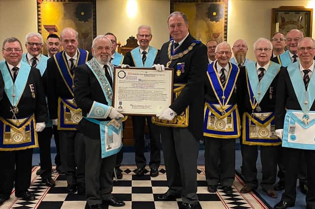 Lincolnshire’s Provincial Grand Master Dave Wheeler presents Skegness St Clement Lodge members with the Centenary Warrant.