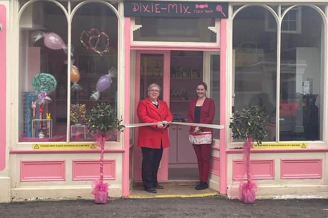 Mayor of Wainfleet Coun Deborah Wickes cutting the ribbon at the opening of the town's Dixie Mix Sweet Shop, with co-owner Cyd Bradford.