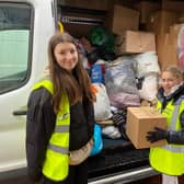 Freya Lyons, 14, and Belle Nicholls, 10, filliing a van with donations at the appeal at the  Seafood Cafe in Skegness.