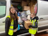 Freya Lyons, 14, and Belle Nicholls, 10, filliing a van with donations at the appeal at the  Seafood Cafe in Skegness.