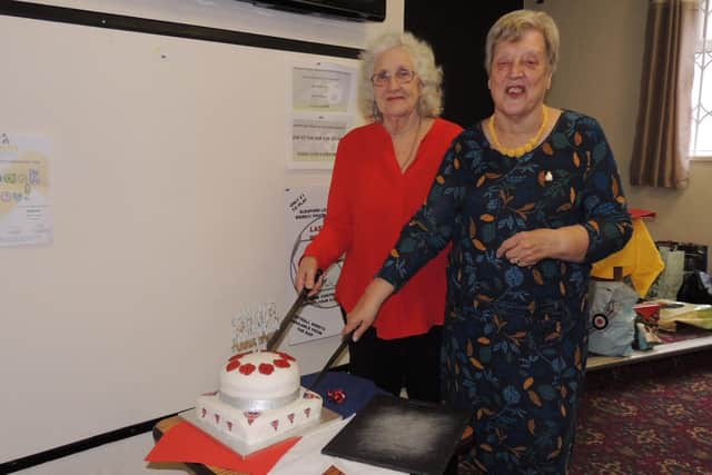 Cutting the anniversary cake on the 5th anniversary of the Camaraderie Club in Lincolnshire - volunteer Jean Cornford (right). EMN-220503-141515001