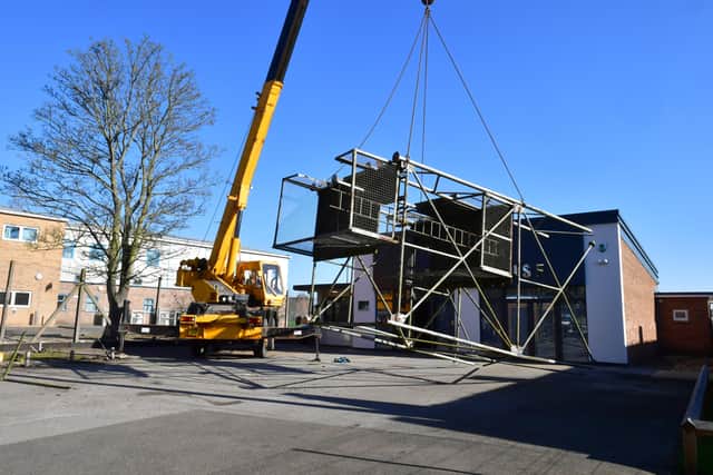 Coming down. The sections of the old fire station tower are lowered to the ground. EMN-220703-165759001