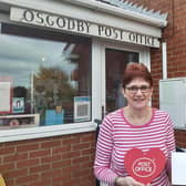 Postmistress Ann Bennett with her award