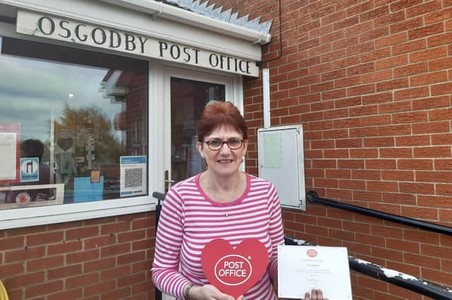 Postmistress Ann Bennett with her award