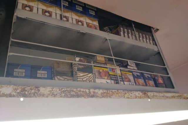 The illegal cigarettes above the ceiling light at the shop in Boston.