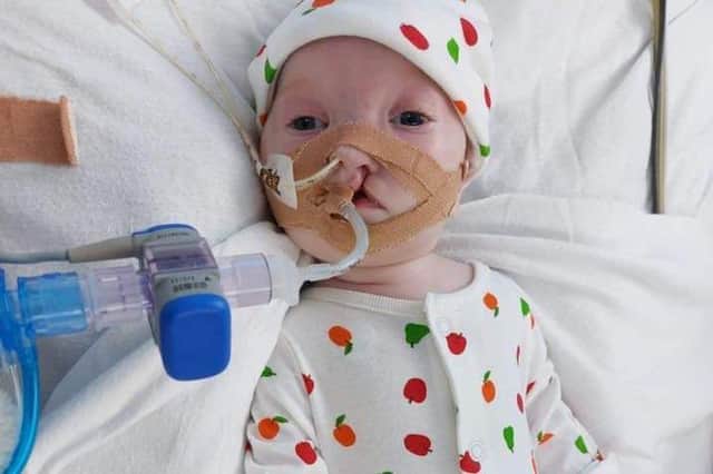 Little Dottie is in intensive care in hospital but her family and the local community are campaigning to bring her home.