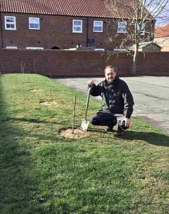 Alex Rutherford-Doak from the Woodland Trust planting trees at the Woolpack Inn, Louth. EMN-220317-101422001