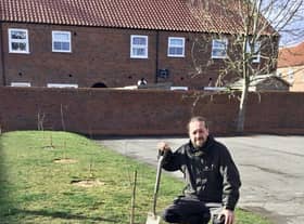 Alex Rutherford-Doak from the Woodland Trust planting trees at the Woolpack Inn, Louth. EMN-220317-101422001