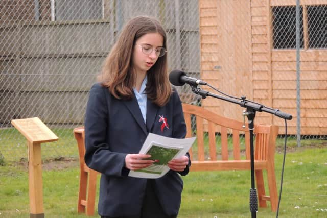 Poetry reading at the Arc of Remembrance ceremony. EMN-220321-143149001