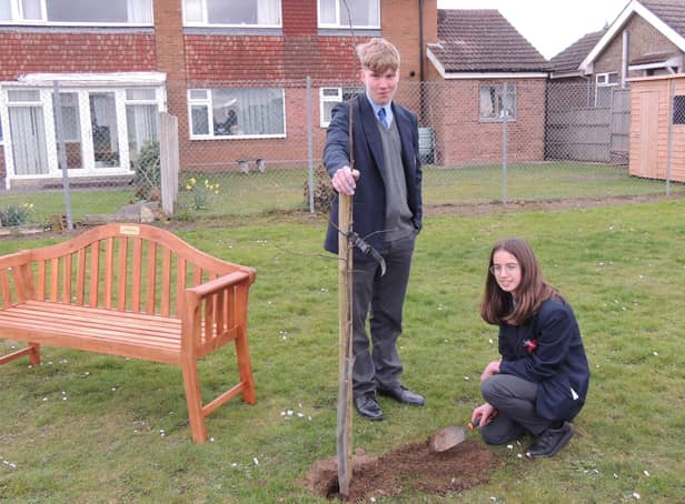 Kieran lloyd, Year 10, and Harriet Giles-Bone, Year 9, planting one of the final trees for the Arc of Remembrance at St George's Academy, Sleaford. EMN-220321-143104001