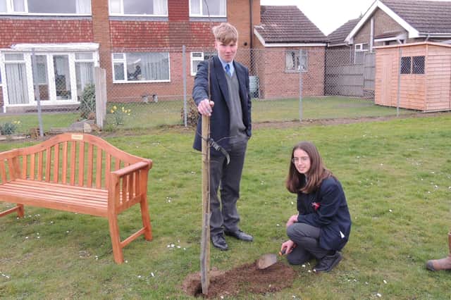 Kieran lloyd, Year 10, and Harriet Giles-Bone, Year 9, planting one of the final trees for the Arc of Remembrance at St George's Academy, Sleaford. EMN-220321-143104001
