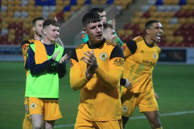 Brad Nicholson and teammates celebrate at the final whistle. Photo: Oliver Atkin