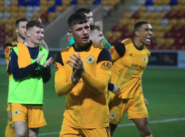 Brad Nicholson and teammates celebrate at the final whistle. Photo: Oliver Atkin