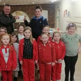 The cheque which was presented to the Rainbows Unit Leader Claire Cartwright  (back row, right) at the Spilsby Pavillion by the Worshipful Master WBro Chris Woods of Shakespeare Lodge 426, which is  based at the Masonic Lodge Spilsby.