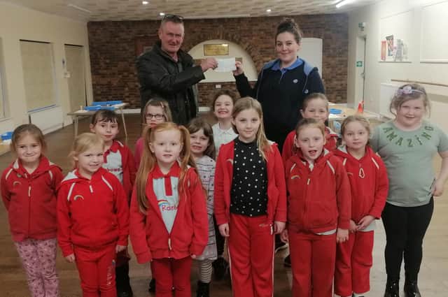 The cheque which was presented to the Rainbows Unit Leader Claire Cartwright (back row, right) at the Spilsby Pavillion by the Worshipful Master WBro Chris Woods of Shakespeare Lodge 426, which is based at the Masonic Lodge Spilsby.