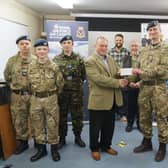 Keith Musson made the presentation to Flt Lt Marcus Hyde, watched by fellow Freemasons  and some of the cadets EMN-220329-090707001