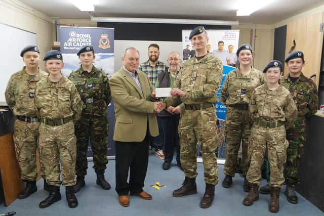 Keith Musson made the presentation to Flt Lt Marcus Hyde, watched by fellow Freemasons  and some of the cadets EMN-220329-090707001